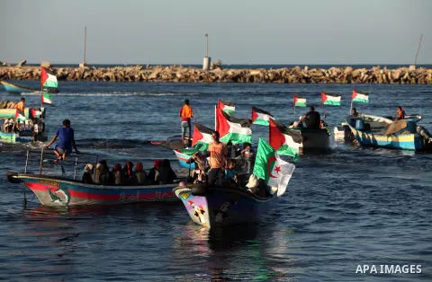 Palestinian women sail boats bearing their national flag in the port of Gaza City in support of the Gaza-bound flotilla of international female activists attempting to break the Israeli blockade on Gaza Strip on October...