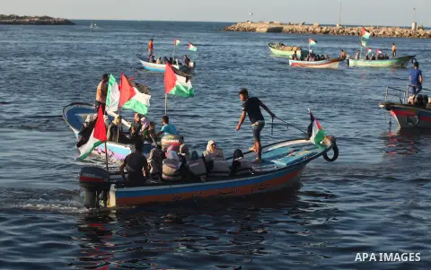 Palestinian women sail boats bearing their national flag in the port of Gaza City in support of the Gaza-bound flotilla of international female activists attempting to break the Israeli blockade on Gaza Strip on October...