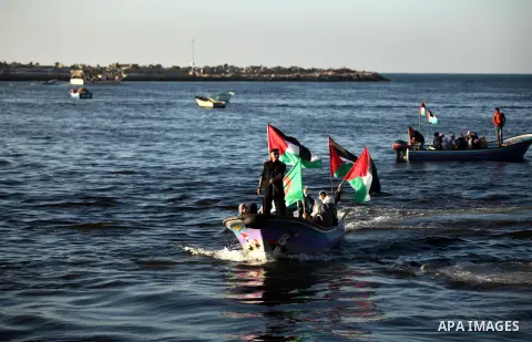 Palestinian women sail boats bearing their national flag in the port of Gaza City in support of the Gaza-bound flotilla of international female activists attempting to break the Israeli blockade on Gaza Strip on October...