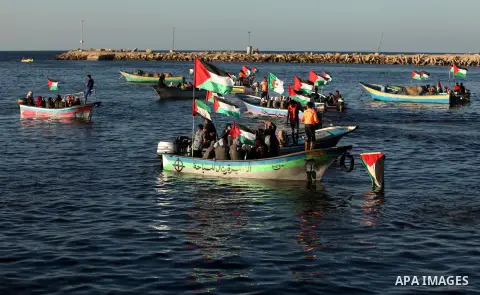 Palestinian women sail boats bearing their national flag in the port of Gaza City in support of the Gaza-bound flotilla of international female activists attempting to break the Israeli blockade on Gaza Strip on October...