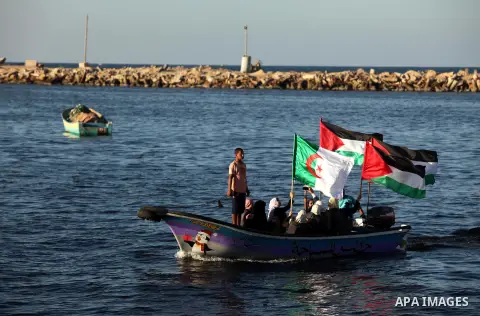 Palestinian women sail boats bearing their national flag in the port of Gaza City in support of the Gaza-bound flotilla of international female activists attempting to break the Israeli blockade on Gaza Strip on October...