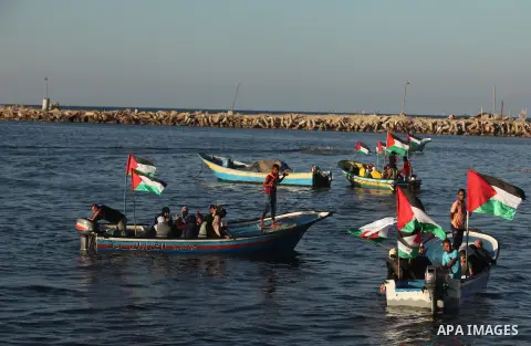 Palestinian women sail boats bearing their national flag in the port of Gaza City in support of the Gaza-bound flotilla of international female activists attempting to break the Israeli blockade on Gaza Strip on October...