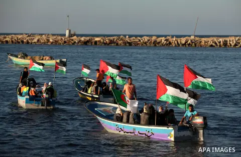 Palestinian women sail boats bearing their national flag in the port of Gaza City in support of the Gaza-bound flotilla of international female activists attempting to break the Israeli blockade on Gaza Strip on October...