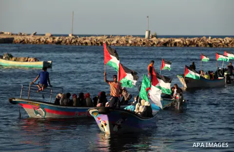 Palestinian women sail boats bearing their national flag in the port of Gaza City in support of the Gaza-bound flotilla of international female activists attempting to break the Israeli blockade on Gaza Strip on October...