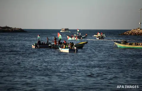 Palestinian women sail boats bearing their national flag in the port of Gaza City in support of the Gaza-bound flotilla of international female activists attempting to break the Israeli blockade on Gaza Strip on October...
