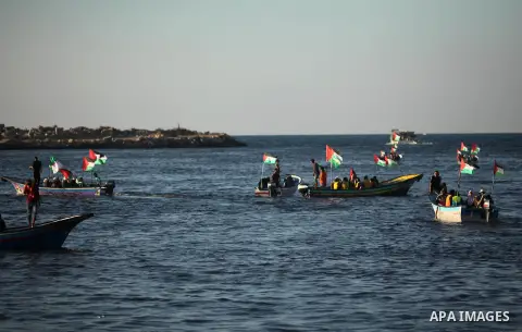 Palestinian women sail boats bearing their national flag in the port of Gaza City in support of the Gaza-bound flotilla of international female activists attempting to break the Israeli blockade on Gaza Strip on October...