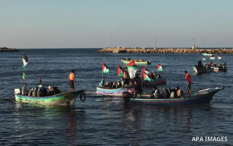 Palestinian women sail boats bearing their national flag in the port of Gaza City in support of the Gaza-bound flotilla of international female activists attempting to break the Israeli blockade on Gaza Strip on October...