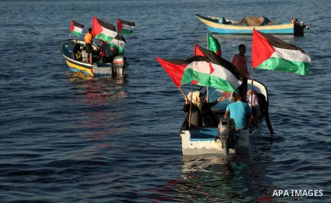 Palestinian women sail boats bearing their national flag in the port of Gaza City in support of the Gaza-bound flotilla of international female activists attempting to break the Israeli blockade on Gaza Strip on October...