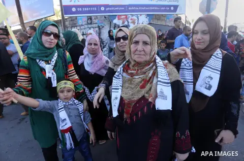 Palestinians who support Palestinian senior Fatah official Mohammed Dahlan, hold banners and national flags during a protest against Palestinian President Mahmoud Abbas in Gaza City on Oct. 06, 2016. Photo by Mohammed As...