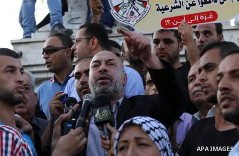 Palestinians who support Palestinian senior Fatah official Mohammed Dahlan, hold banners and national flags during a protest against Palestinian President Mahmoud Abbas in Gaza City on Oct. 06, 2016. Photo by Mohammed As...