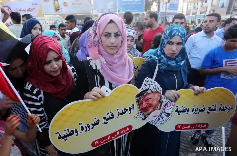 Palestinians who support Palestinian senior Fatah official Mohammed Dahlan, hold banners and national flags during a protest against Palestinian President Mahmoud Abbas in Gaza City on Oct. 06, 2016. Photo by Mohammed As...