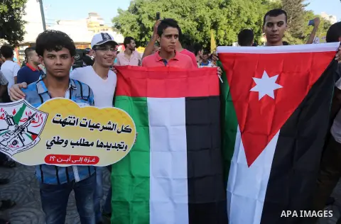 Palestinians who support Palestinian senior Fatah official Mohammed Dahlan, hold banners and national flags during a protest against Palestinian President Mahmoud Abbas in Gaza City on Oct. 06, 2016. Photo by Mohammed As...