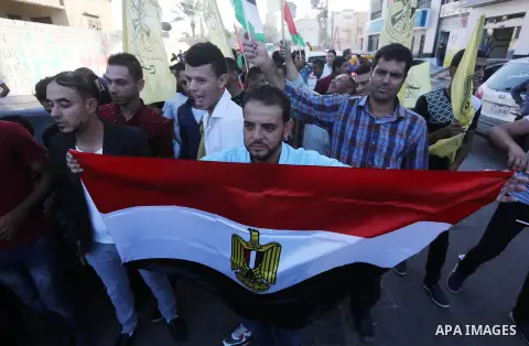 Palestinians who support Palestinian senior Fatah official Mohammed Dahlan, hold banners and national flags during a protest against Palestinian President Mahmoud Abbas in Gaza City on Oct. 06, 2016. Photo by Mohammed As...