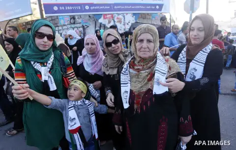 Palestinians who support Palestinian senior Fatah official Mohammed Dahlan, hold banners and national flags during a protest against Palestinian President Mahmoud Abbas in Gaza City on Oct. 06, 2016. Photo by Mohammed As...