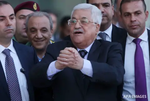 Palestinian President Mahmoud Abbas gestures after leaving a hospital in the in the West Bank city of Ramallah October 6, 2016. Photo by Shadi Hatem