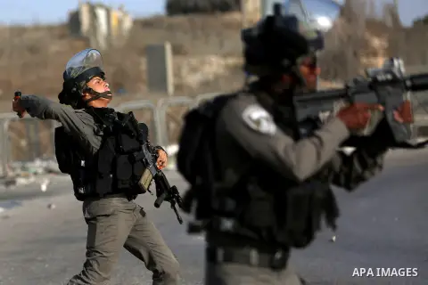 An Israeli border policeman is seen as he fired a tear gas canister during clashes with Palestinian protesters in the West Bank town of Al-Ram, near Jerusalem October 9, 2016. A Palestinian opened fire from a car in Jeru...