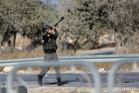 An Israeli border policeman is seen as he fired a tear gas canister during clashes with Palestinian protesters in the West Bank town of Al-Ram, near Jerusalem October 9, 2016. A Palestinian opened fire from a car in Jeru...