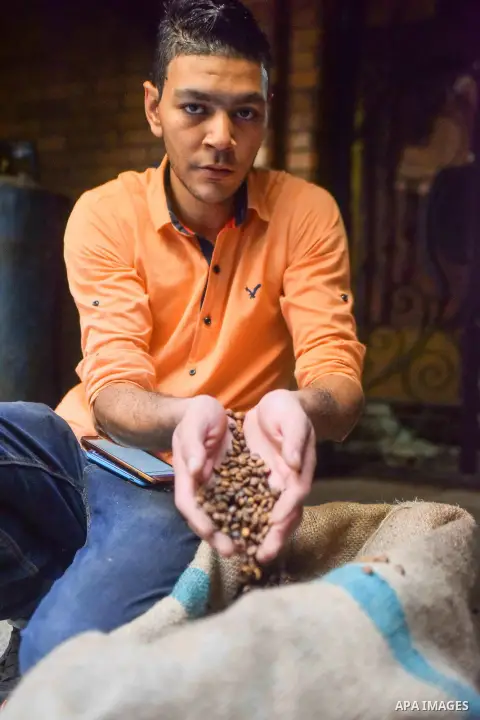 An Egyptian man makes a coffee at a factory, in Cairo, Egypt on October 11, 2016. The shop of Abdul Salam Al-banan is one of the oldest shops of the coffee industry in Egypt. Photo by Amr Sayed