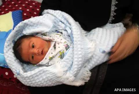 Tahany Shaath holds her three-day-old new-born son Waleed at their house in the southern Gaza Strip town of Rafah on October 12, 2016. The two millionth person has been born in Gaza, with the birth Waleed officially reco...