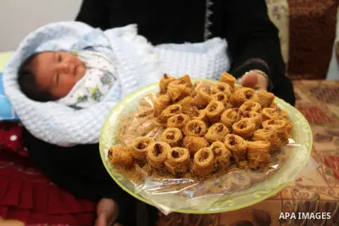 Tahany Shaath holds her three-day-old new-born son Waleed at their house in the southern Gaza Strip town of Rafah on October 12, 2016. The two millionth person has been born in Gaza, with the birth Waleed officially reco...