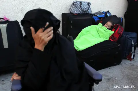 Palestinians wait for travel permits to cross into Egypt through the Rafah border crossing on October 15, 2016 in the southern Gaza Strip. Egyptian authorities temporarily reopened the crossing both directions for two da...
