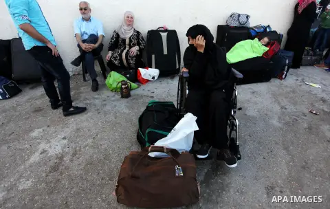 Palestinians wait for travel permits to cross into Egypt through the Rafah border crossing on October 15, 2016 in the southern Gaza Strip. Egyptian authorities temporarily reopened the crossing both directions for two da...