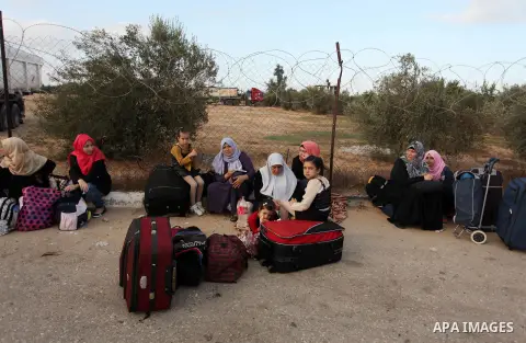Palestinians wait for travel permits to cross into Egypt through the Rafah border crossing on October 15, 2016 in the southern Gaza Strip. Egyptian authorities temporarily reopened the crossing both directions for two da...