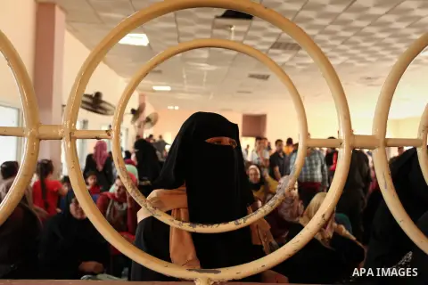 Palestinians wait for travel permits to cross into Egypt through the Rafah border crossing on October 15, 2016 in the southern Gaza Strip. Egyptian authorities temporarily reopened the crossing both directions for two da...