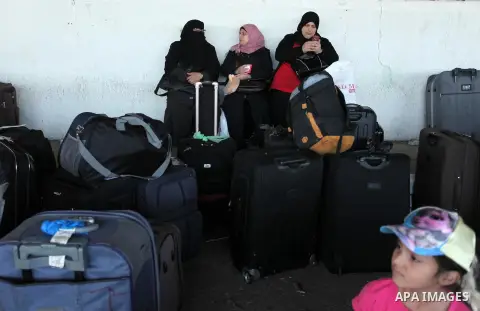 Palestinians wait for travel permits to cross into Egypt through the Rafah border crossing on October 15, 2016 in the southern Gaza Strip. Egyptian authorities temporarily reopened the crossing both directions for two da...