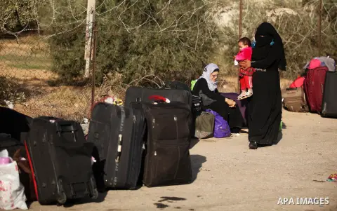 Palestinians wait for travel permits to cross into Egypt through the Rafah border crossing on October 15, 2016 in the southern Gaza Strip. Egyptian authorities temporarily reopened the crossing both directions for two da...