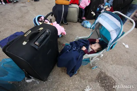Palestinian childern sleep on a suitcase as they wait with their family for a travel permit to cross into Egypt through the Rafah border crossing on October 15, 2016 in the southern Gaza Strip. Egyptian authorities tempo...