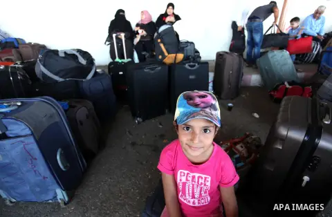 Palestinians wait for travel permits to cross into Egypt through the Rafah border crossing on October 15, 2016 in the southern Gaza Strip. Egyptian authorities temporarily reopened the crossing both directions for two da...