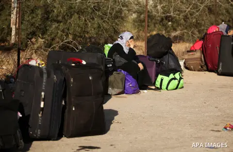 Palestinians wait for travel permits to cross into Egypt through the Rafah border crossing on October 15, 2016 in the southern Gaza Strip. Egyptian authorities temporarily reopened the crossing both directions for two da...