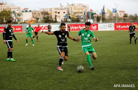Shabab Hebron players and Ozlan south (Zahryah) players compete during the final match of the Palestinian Cup (Abu Ammar Cup), in the West Bank city of Hebron, on October 15, 2016. Photo by Wisam Hashlamoun