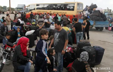 Palestinians wait for travel permits to cross into Egypt through the Rafah border crossing after it was opened by Egyptian authorities for humanitarian cases, in Rafah in the southern Gaza Strip October 19, 2016. Photo b...