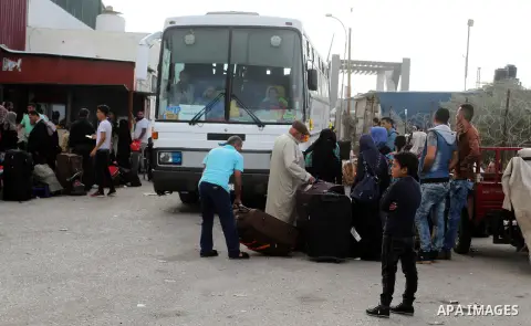 Palestinians wait for travel permits to cross into Egypt through the Rafah border crossing after it was opened by Egyptian authorities for humanitarian cases, in Rafah in the southern Gaza Strip October 19, 2016. Photo b...