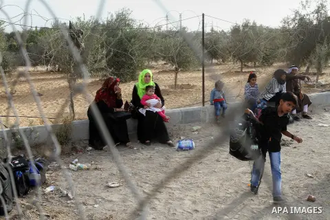 Palestinians wait for travel permits to cross into Egypt through the Rafah border crossing after it was opened by Egyptian authorities for humanitarian cases, in Rafah in the southern Gaza Strip October 19, 2016. Photo b...