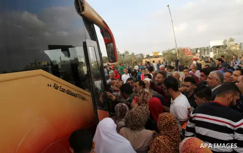 Palestinians wait for travel permits to cross into Egypt through the Rafah border crossing after it was opened by Egyptian authorities for humanitarian cases, in Rafah in the southern Gaza Strip October 19, 2016. Photo b...