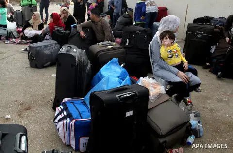 Palestinians wait for travel permits to cross into Egypt through the Rafah border crossing after it was opened by Egyptian authorities for humanitarian cases, in Rafah in the southern Gaza Strip October 19, 2016. Photo b...