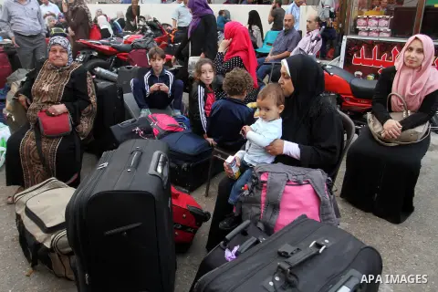 Palestinians wait for travel permits to cross into Egypt through the Rafah border crossing after it was opened by Egyptian authorities for humanitarian cases, in Rafah in the southern Gaza Strip October 19, 2016. Photo b...