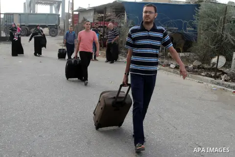 Palestinians wait for travel permits to cross into Egypt through the Rafah border crossing after it was opened by Egyptian authorities for humanitarian cases, in Rafah in the southern Gaza Strip October 19, 2016. Photo b...