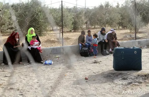 Palestinians wait for travel permits to cross into Egypt through the Rafah border crossing after it was opened by Egyptian authorities for humanitarian cases, in Rafah in the southern Gaza Strip October 19, 2016. Photo b...