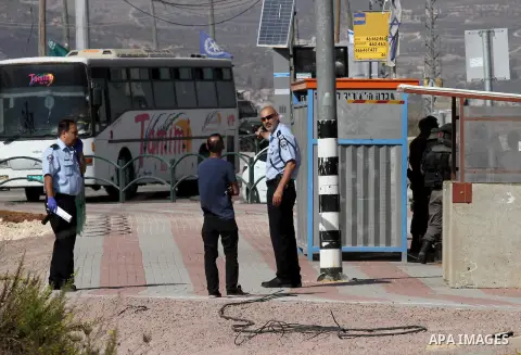 Israeli security forces gather at the site where a Palestinian woman attempted to stab an Israeli border police with a knife before being shot dead, near the Tapuah junction, also known as the Zaatara junction, south of...
