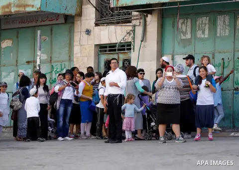 Israeli settlers visit the Jewish shrine of Atnaeil Ben Kinaz during the Jewish Sukkot holiday or the feast of the Tabernacles in a Palestinian neighbourhood of the divided West Bank city of Hebron on Oct. 19, 2016. Phot...