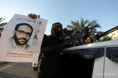 Palestinian Islamic Jihad militants hold their weapons during a military parade marking the 29 anniversary of their group in Gaza October 19, 2016. Photo by Ashraf Amra