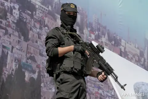 A Palestinian Islamic Jihad militant stands guard during a rally marking the 29th anniversary of the movement foundation in Gaza City October 21, 2016. Photo by Abed Rahim Khatib
