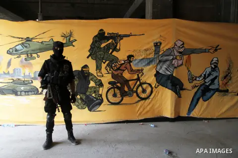 A Palestinian Islamic Jihad militant stands guard during a rally marking the 29th anniversary of the movement foundation in Gaza City October 21, 2016. Photo by Abed Rahim Khatib