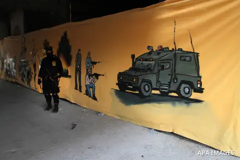 A Palestinian Islamic Jihad militant stands guard during a rally marking the 29th anniversary of the movement foundation in Gaza City October 21, 2016. Photo by Abed Rahim Khatib