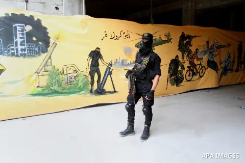 A Palestinian Islamic Jihad militant stands guard during a rally marking the 29th anniversary of the movement foundation in Gaza City October 21, 2016. Photo by Abed Rahim Khatib