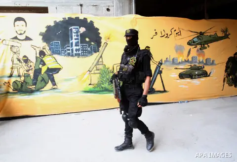 A Palestinian Islamic Jihad militant stands guard during a rally marking the 29th anniversary of the movement foundation in Gaza City October 21, 2016. Photo by Abed Rahim Khatib